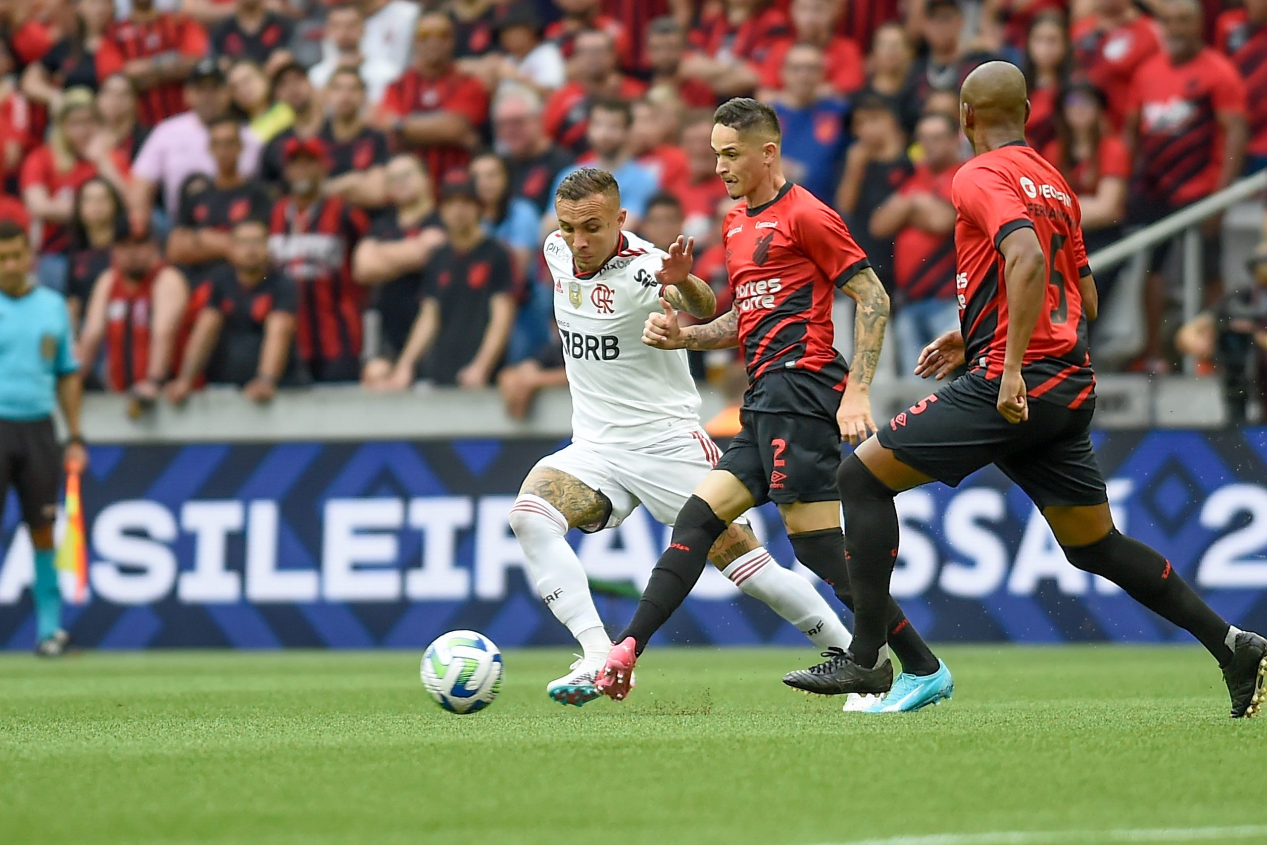 Wesley and Lucas Silva of Cruzeiro and Gerson of Flamengo fight